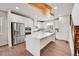 Bright kitchen features stainless steel appliances, white cabinets, and a large center island at 3574 Corsica Way, Castle Rock, CO 80109