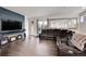 Spacious living room features hardwood floors, a modern sofa, and a blue accent wall at 3574 Corsica Way, Castle Rock, CO 80109