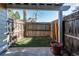 Enclosed backyard with a privacy fence, small patch of grass, and a patio area perfect for relaxation at 4010 S Rifle Way, Aurora, CO 80013