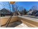 Top-floor balcony with a view of a quiet, tree-lined street at 4010 S Rifle Way, Aurora, CO 80013