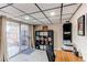 Basement room with desk area, sliding door to the outside, and neutral colored carpet at 4010 S Rifle Way, Aurora, CO 80013