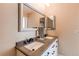Bathroom featuring double sinks, framed mirrors, and modern faucets on a light-colored countertop at 4010 S Rifle Way, Aurora, CO 80013