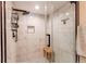 Bathroom showcasing walk-in glass shower with rain shower head, marble tile, and black accents at 4010 S Rifle Way, Aurora, CO 80013