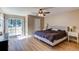 Spacious bedroom with a ceiling fan, and sliding glass door to a balcony at 4010 S Rifle Way, Aurora, CO 80013