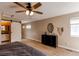 Primary bedroom showcasing hardwood floors, a ceiling fan, and a sliding barn door to the bathroom at 4010 S Rifle Way, Aurora, CO 80013
