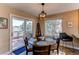Charming dining area with a round table, stylish light fixture, and view to a deck at 4010 S Rifle Way, Aurora, CO 80013
