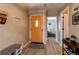 Bright entryway with hardwood floors and a decorative orange door at 4010 S Rifle Way, Aurora, CO 80013