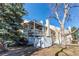 Two-story home with a pergola-covered balcony and white fence at 4010 S Rifle Way, Aurora, CO 80013