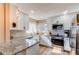 Modern kitchen with stainless steel appliances, granite countertops, and white cabinetry at 4010 S Rifle Way, Aurora, CO 80013
