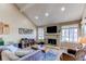 Bright living room with a fireplace, large windows, and modern furnishings at 4010 S Rifle Way, Aurora, CO 80013