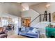 Inviting living room with vaulted ceiling, modern staircase, and open floor plan to kitchen at 4010 S Rifle Way, Aurora, CO 80013