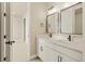 Elegant bathroom featuring double sinks, modern mirrors, and a walk-in shower; providing a luxurious and convenient space at 39417 Stockton Cir, Elizabeth, CO 80107