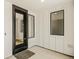 Bright entryway features black trimmed windows, white walls, and a modern black front door at 39417 Stockton Cir, Elizabeth, CO 80107