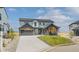 Beautiful two-story home featuring modern gray siding, a spacious driveway, and manicured landscaping at 39417 Stockton Cir, Elizabeth, CO 80107