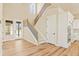 Bright foyer with staircase, wood floors, and access to the kitchen and entry at 39417 Stockton Cir, Elizabeth, CO 80107