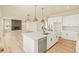 Spacious kitchen with island, stainless appliances, and open floorplan to the living room and fireplace at 39417 Stockton Cir, Elizabeth, CO 80107