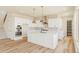 This bright kitchen features quartz countertops, an island, stainless steel appliances, and modern fixtures at 39417 Stockton Cir, Elizabeth, CO 80107