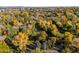 Stunning aerial view of the neighborhood in autumn, showcasing vibrant fall foliage and mature trees at 6 Martin Ln, Englewood, CO 80113