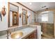 Bathroom offering dual mirrors, decorative sconces, custom tilework, and a luxurious glass enclosed shower at 6 Martin Ln, Englewood, CO 80113