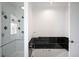 Bathroom with glass enclosed shower featuring decorative tiles and a relaxing soaking tub with modern fixtures at 6 Martin Ln, Englewood, CO 80113