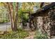 Charming entrance with stone wall and wooden gate, surrounded by foliage at 6 Martin Ln, Englewood, CO 80113