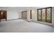 Spacious living room featuring leaded glass windows that illuminate the soft, neutral decor and plush carpeting at 6 Martin Ln, Englewood, CO 80113