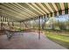 Covered brick patio features outdoor seating and views of the landscaped backyard at 6 Martin Ln, Englewood, CO 80113