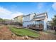 An exterior view of the home's backyard showcasing a deck and well manicured yard and landscaping at 12388 Jasmine St, Brighton, CO 80602