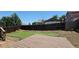A backyard showcasing a wooden deck and partially completed artificial turf putting green, enclosed by a wood fence at 12388 Jasmine St, Brighton, CO 80602