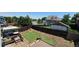 Spacious backyard featuring a partially completed artificial turf putting green and wooden deck, enclosed by a wood fence at 12388 Jasmine St, Brighton, CO 80602
