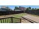 Backyard features partially completed artificial turf putting green and wooden deck, enclosed by a dark wood fence at 12388 Jasmine St, Brighton, CO 80602