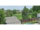 Scenic view from backyard overlooking a lush green space, enhanced by mature trees and neighboring homes at 12388 Jasmine St, Brighton, CO 80602
