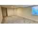 This unfinished basement space has carpeting and a window at 12388 Jasmine St, Brighton, CO 80602