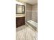 Bathroom featuring a shower with tile surround and a vanity with dark cabinetry at 12388 Jasmine St, Brighton, CO 80602