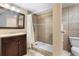 Updated bathroom with tiled shower, vanity, and a toilet at 12388 Jasmine St, Brighton, CO 80602