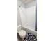 This bathroom features a shower/tub with white tile surround, toilet, and neutral-colored walls at 12388 Jasmine St, Brighton, CO 80602