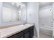 Clean bathroom features a large mirror, vanity, and a shower/tub combo at 12388 Jasmine St, Brighton, CO 80602