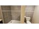 This bathroom features a tiled shower and toilet at 12388 Jasmine St, Brighton, CO 80602