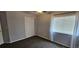 This bedroom features carpet, gray walls, a window with blinds and curtains, and a closet at 12388 Jasmine St, Brighton, CO 80602