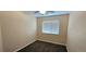 This bedroom has neutral carpet, light tan walls, and one window covered with mini-blinds at 12388 Jasmine St, Brighton, CO 80602