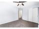 Empty bedroom with plush carpeting and closet with ample space for storage at 12388 Jasmine St, Brighton, CO 80602