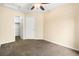 Empty bedroom featuring plush carpeting, a ceiling fan, and a closet for storage at 12388 Jasmine St, Brighton, CO 80602