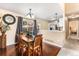 Inviting dining room features hardwood floors and a charming chandelier, perfect for Gathering meals at 12388 Jasmine St, Brighton, CO 80602