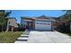 Well-maintained two-story home featuring gray siding, a two-car garage and a concrete driveway at 12388 Jasmine St, Brighton, CO 80602