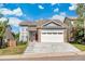 Two-story home featuring blue siding, mature trees and a two car garage at 12388 Jasmine St, Brighton, CO 80602