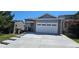 Attractive home featuring gray siding, a two-car garage, concrete driveway, and manicured lawn at 12388 Jasmine St, Brighton, CO 80602