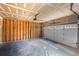 Unfinished garage with a roll up door at 12388 Jasmine St, Brighton, CO 80602