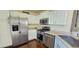 Well-lit kitchen features stainless steel appliances and white cabinetry at 12388 Jasmine St, Brighton, CO 80602