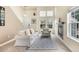 Inviting living room with tall ceilings, lots of natural light, and a cozy fireplace at 12388 Jasmine St, Brighton, CO 80602