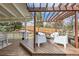 Relaxing outdoor seating area on a wooden deck with a pergola overhead overlooking the yard at 17979 E Dorado Dr, Centennial, CO 80015